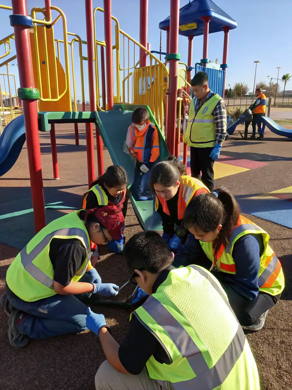 An image of maintenance staff inspecting playground equipment and cleaning outdoor areas, ensuring a safe and inviting environment for children.